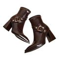 Pair of brown leather boots with buckles on a white background
