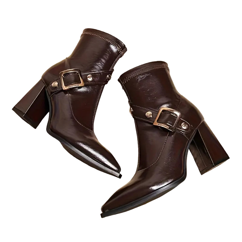 Pair of brown leather boots with buckles on a white background
