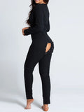Black buttoned sexy women's pajama jumpsuit with open bum flap and holiday christmas print design