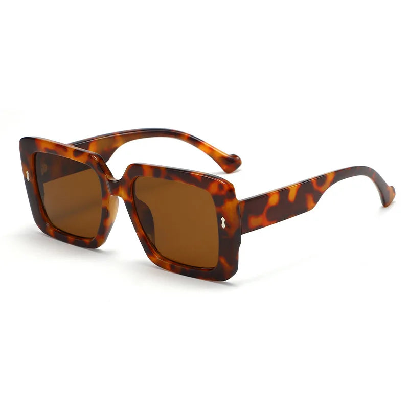 Sunglasses with green and red striped arms on a white background