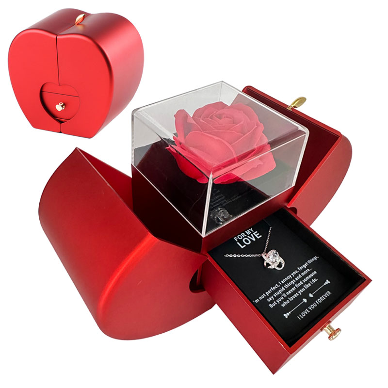 Red heart-shaped box with a rose and necklace inside on a white background