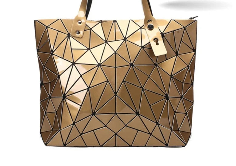 A gold-colored, geometric patterned handbag for women with two handles and a zipper closure.