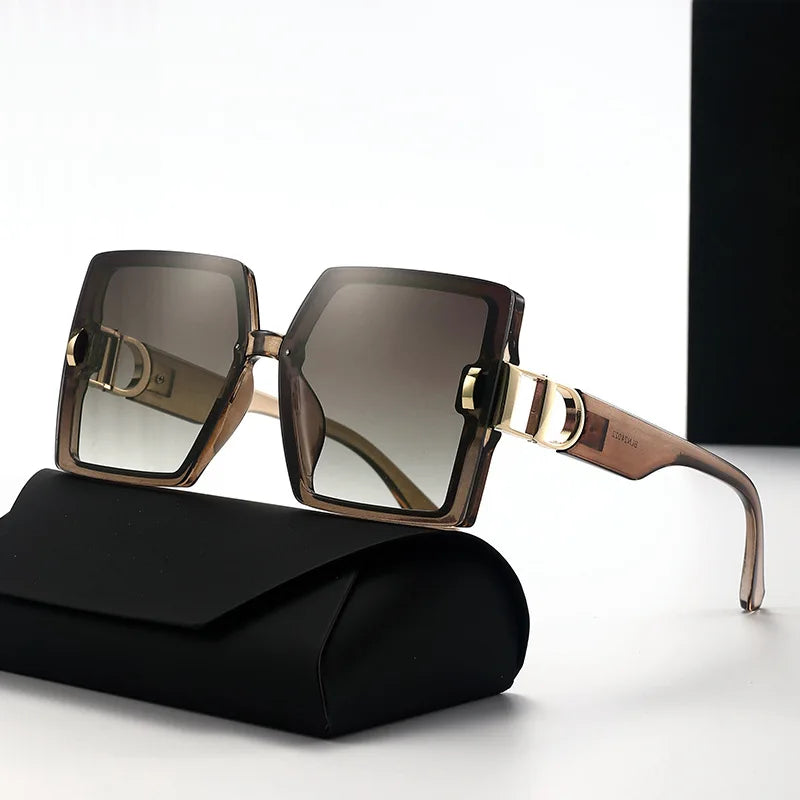 Sunglasses with gold accents on a black case against a white background