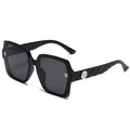 Black sunglasses with a brand logo on a white background
