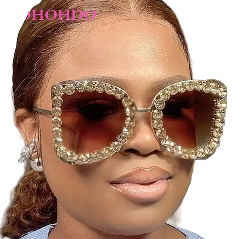 Person wearing large, ornate sunglasses with aDOHOHDO branding.