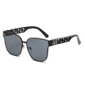 Black sunglasses with decorative arms on a white background