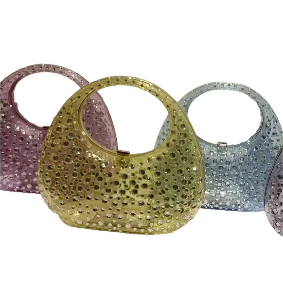 Three glittery clutch in pink, gold, and silver on a white background