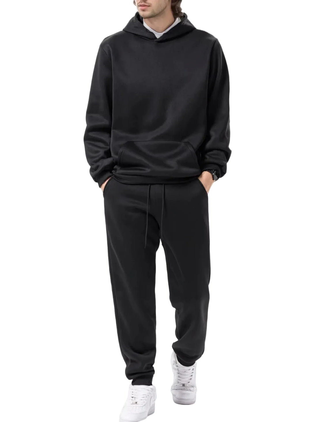 Person wearing a black tracksuit on a white background