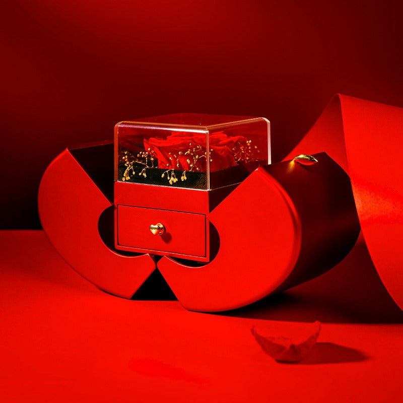 Red jewelry box with a heart design on a red background