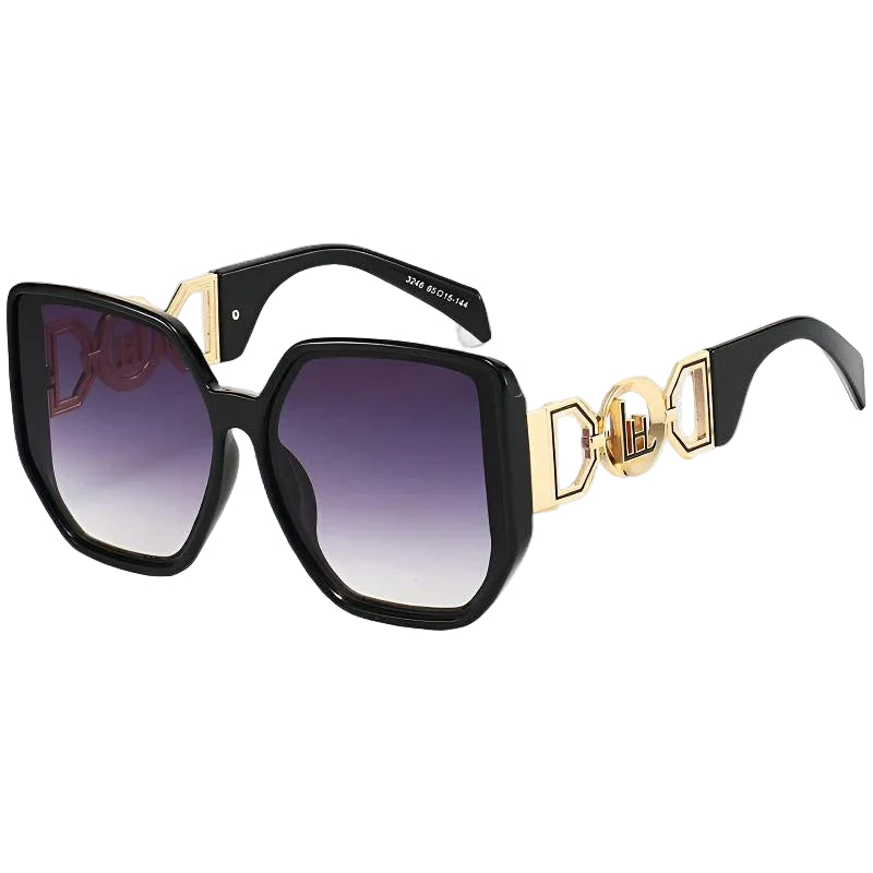Sunglasses with black frame, gold accents, and gradient lenses on a white background