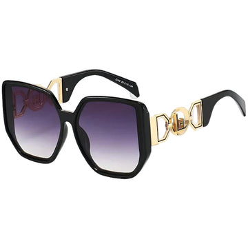 Sunglasses with black frame, gold accents, and gradient lenses on a white background