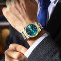 Refined men’s quartz waterproof watch with blue dial, luminous hands, date display, gold and silver stainless steel strap, worn with formal suit style