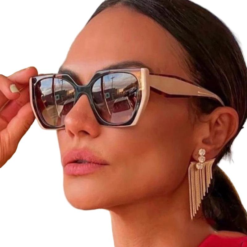 Close-up of a woman wearing sunglasses with a blurred background