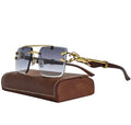Gold-framed sunglasses with clear lenses on a brown leather case against a white background