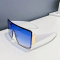 Sunglasses with blue gradient lenses and gold accents on a white surface.