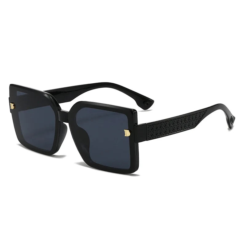Black sunglasses with gold accents on a white background