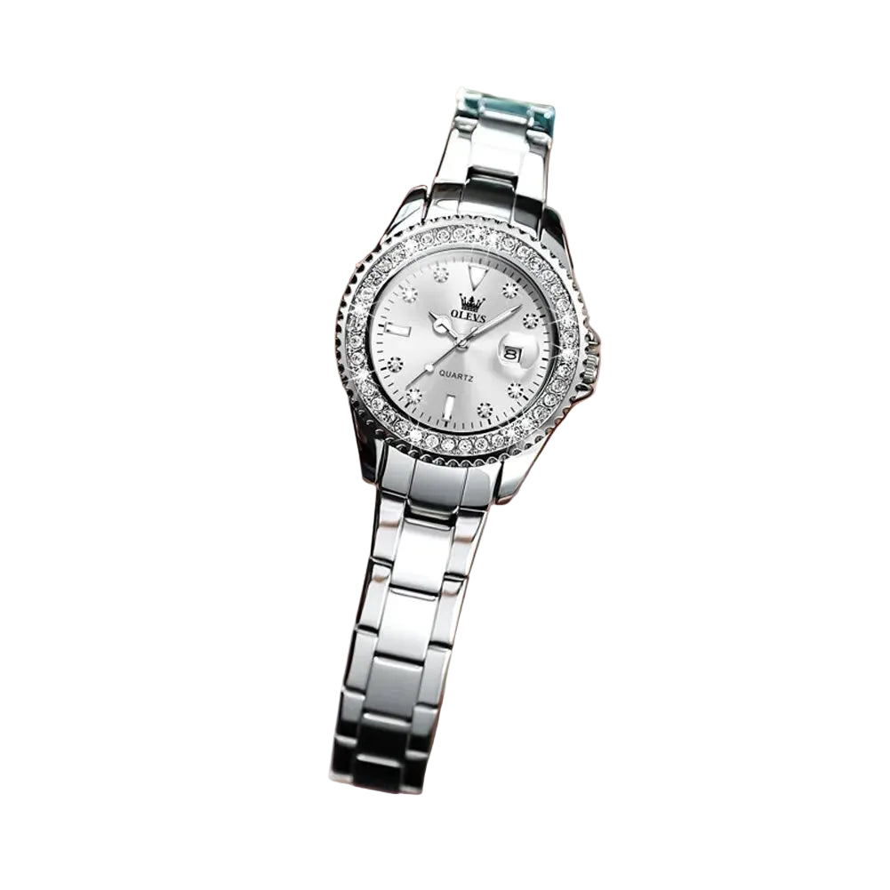 Trendy silver wristwatch with decorative face held by a hand, brand 'OLEVS' visible on a white background
