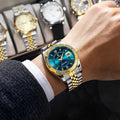 Versatile men’s waterproof watch with blue dial, luminous hands, date display, gold and silver stainless steel finish, worn with elegant formal outfit
