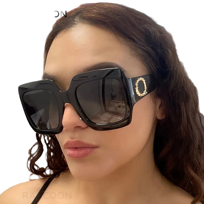 Person wearing large black sunglasses with a brand logo in the corner