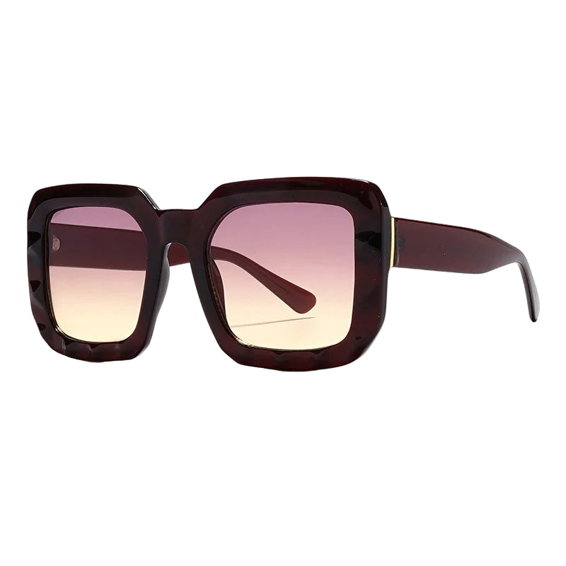 Sunglasses with a gradient pink to brown frame on a white background
