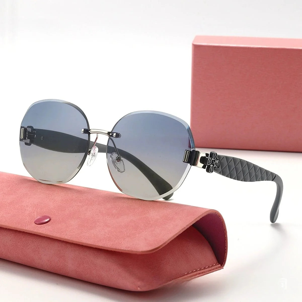 Sunglasses with a pink case on a white background