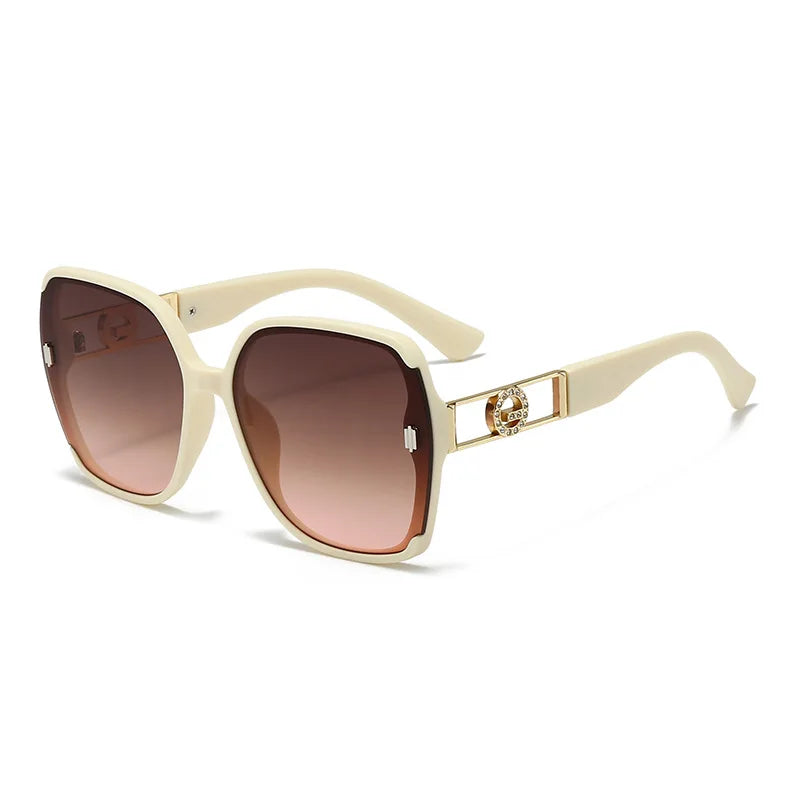 Beige sunglasses with brown gradient lenses on a white background