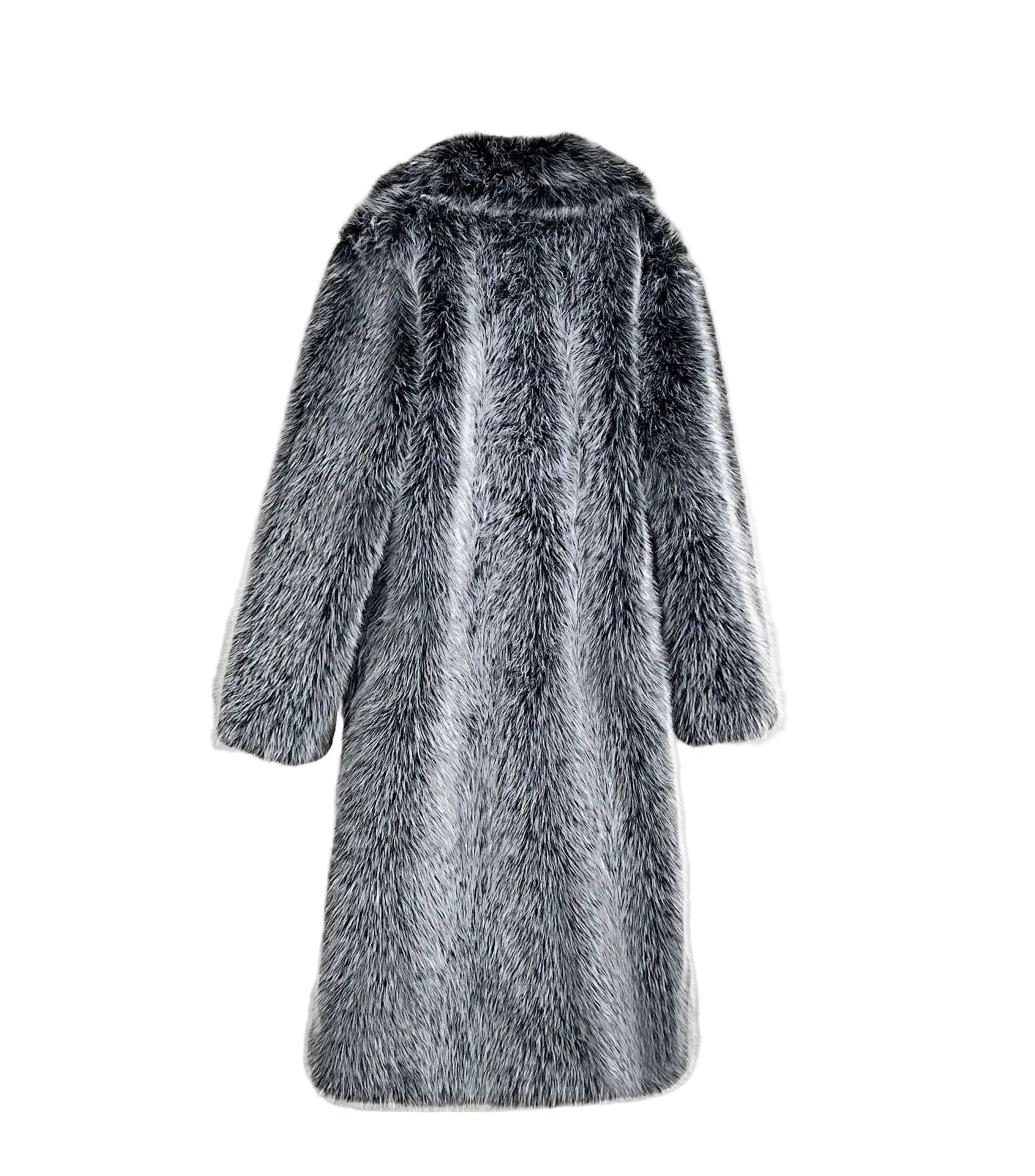 Gray fur coat hanging on a white wall with a gray chair in the background.