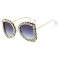 Sunglasses with decorative frame and gradient lenses on a white background