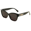 Black sunglasses with a gold logo on a beige background
