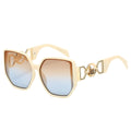 Gold-framed sunglasses with gradient lenses on a white background