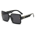 Black sunglasses with decorative frame on a white background