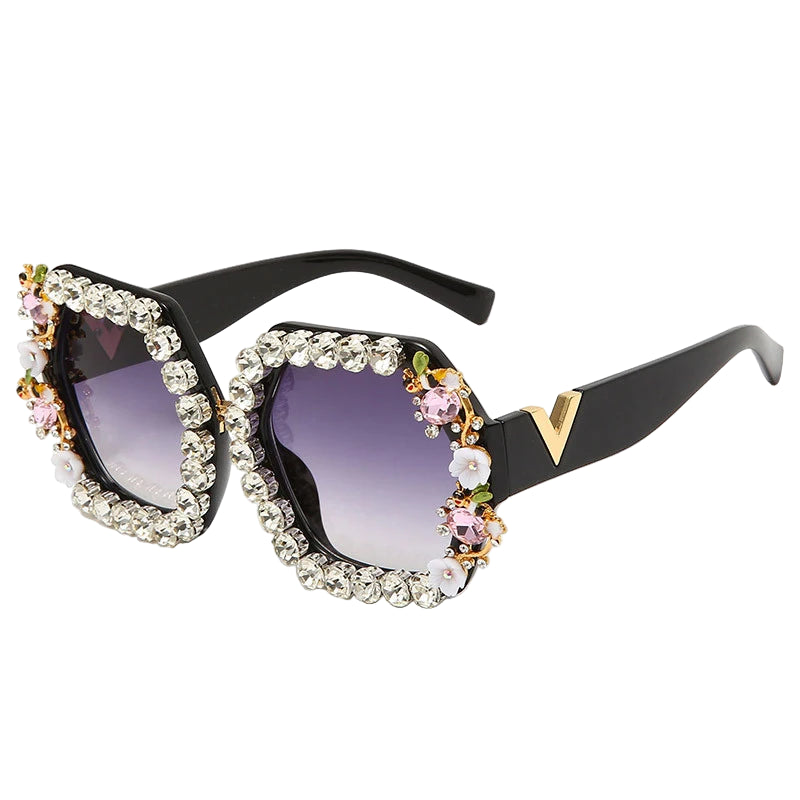 Sunglasses with decorative frame and purple lenses on a white background