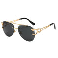 Sunglasses with gold frame and black lenses on a white background