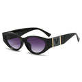 Black cat-eye sunglasses with gold accents on a white background