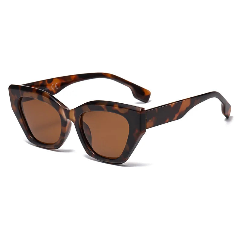 Tortoiseshell cat-eye sunglasses with brown lenses on a white background