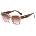 Sunglasses with a brown gradient lens and decorative frame on a white background