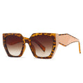Sunglasses with tortoiseshell frame and brown gradient lenses on a white background
