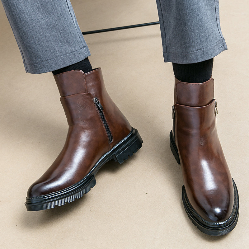 Brown leather boots worn with gray pants on a beige background