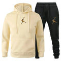 Beige hoodie and black pants with a logo on a white background