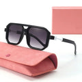 Black sunglasses with a pink case on a white background