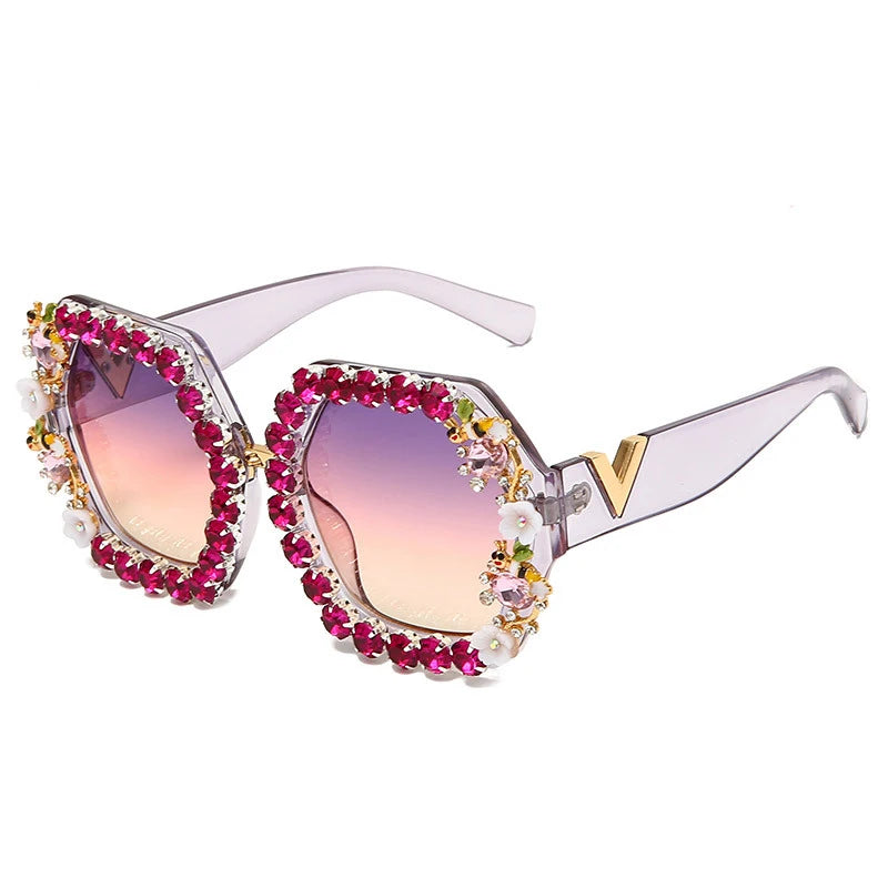 Sunglasses with pink lenses and decorative embellishments on a white background