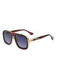 Sunglasses with gold and red frame on a white surface with a blue background