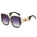 Sunglasses with tortoiseshell frame and gold accents on a white background