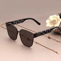 Sunglasses with a chain on a light background