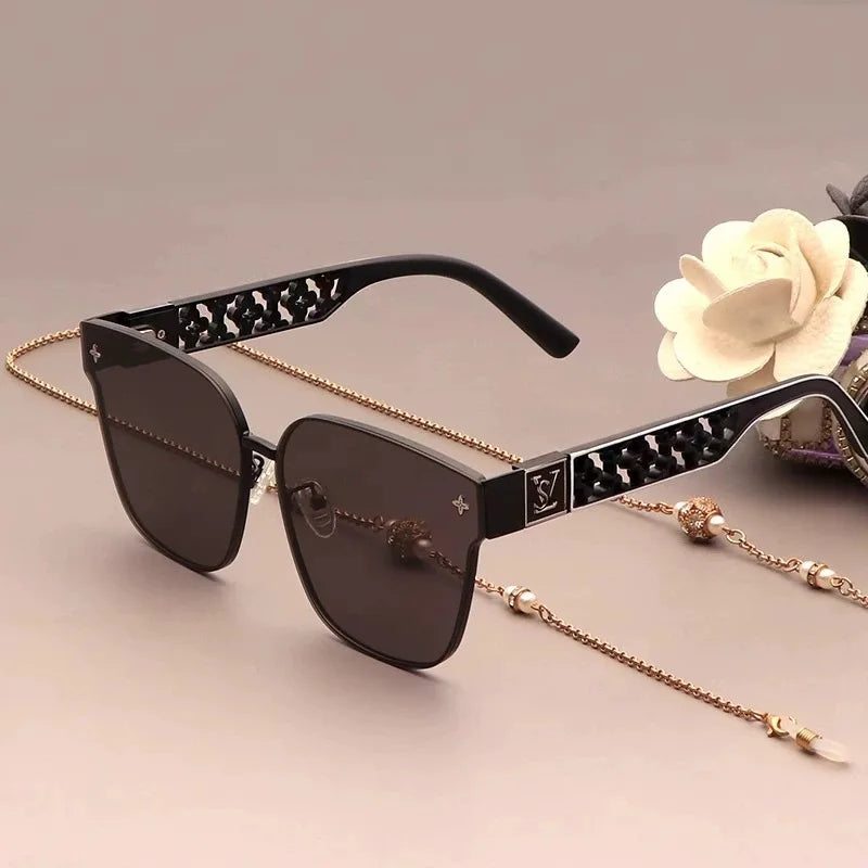 Sunglasses with a chain on a light background