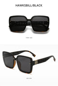 Sunglasses with decorative frame and dark lenses on a white background