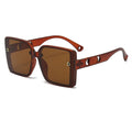 Brown sunglasses with a gold logo on a white background