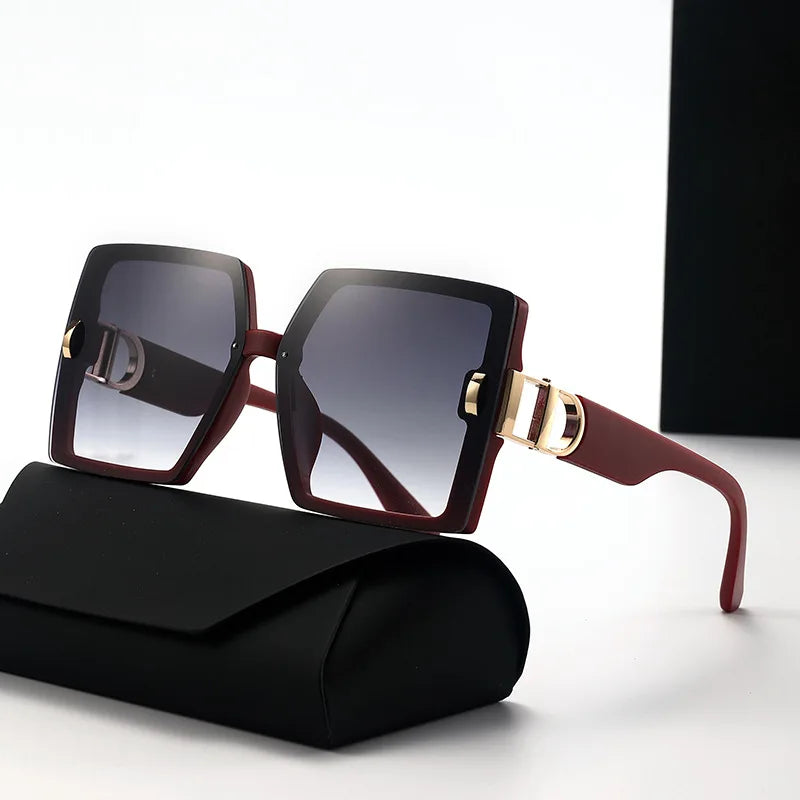 Sunglasses with gold accents on a black case against a white background