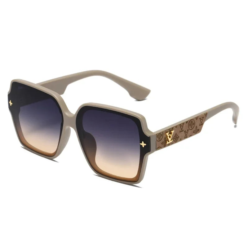 Sunglass with a decorative golden V on the arms on a white background