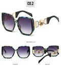 Sunglasses with decorative frame and gradient lenses on a white background